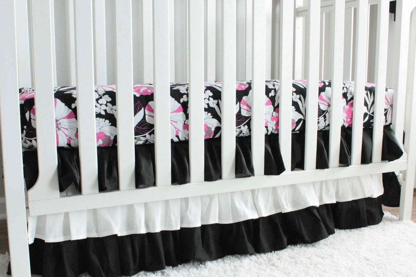 Black and white 3 tiered Crib Skirt. Pink and black floral crib sheet. Nursery bedding. In stock.